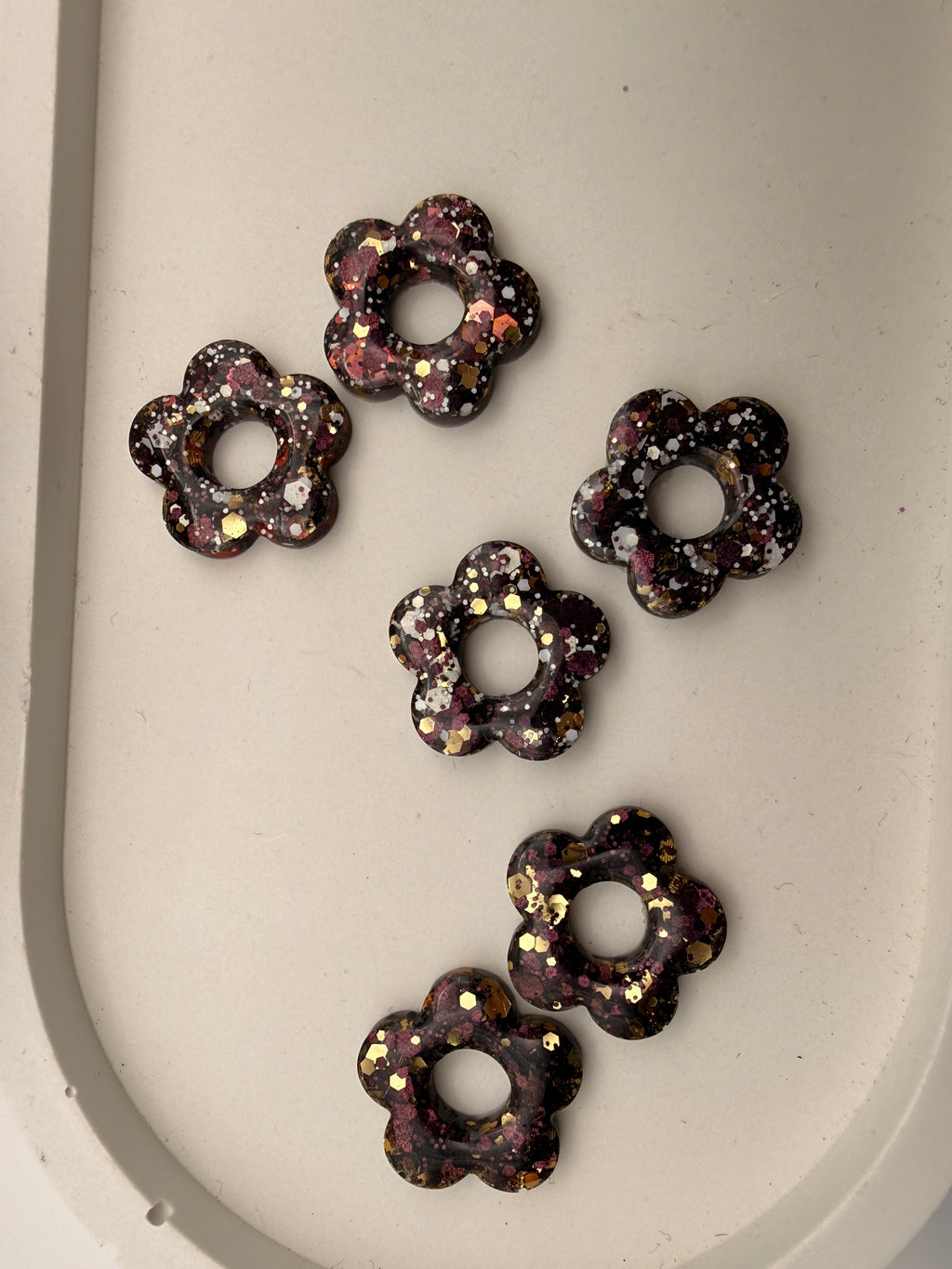 Les trois exemplaires de la pampille fleur en résine camaïeu d'automne pour boucles d'oreilles interchangeables, faits main en Dordogne